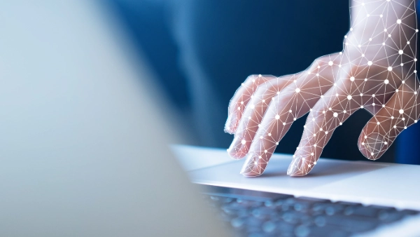 Hand operates the touchpad of a laptop