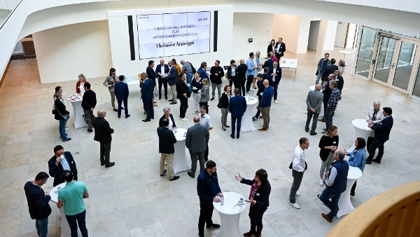 A group of people in the foyer in a business context.