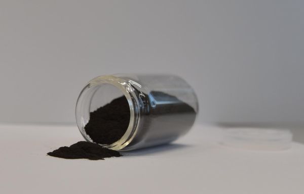 AGXX powder spilling out of a jar laying on its side 