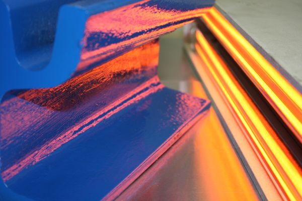 Infrared light dries the paint on a metal part