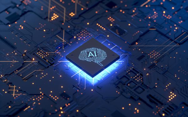 システムを動かす小さな脳と「AI」の文字がプリントされた、光るコンピューターチップ。 